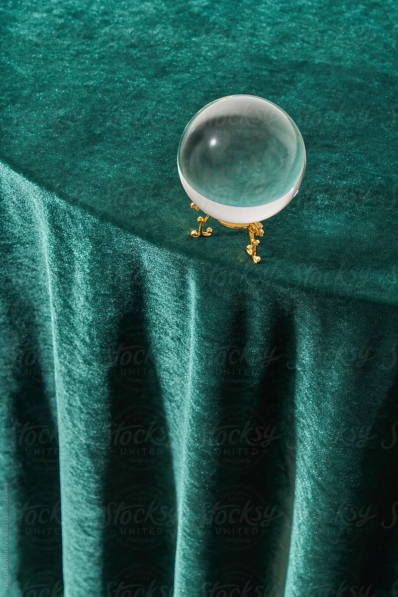 Magic crystal ball on green background