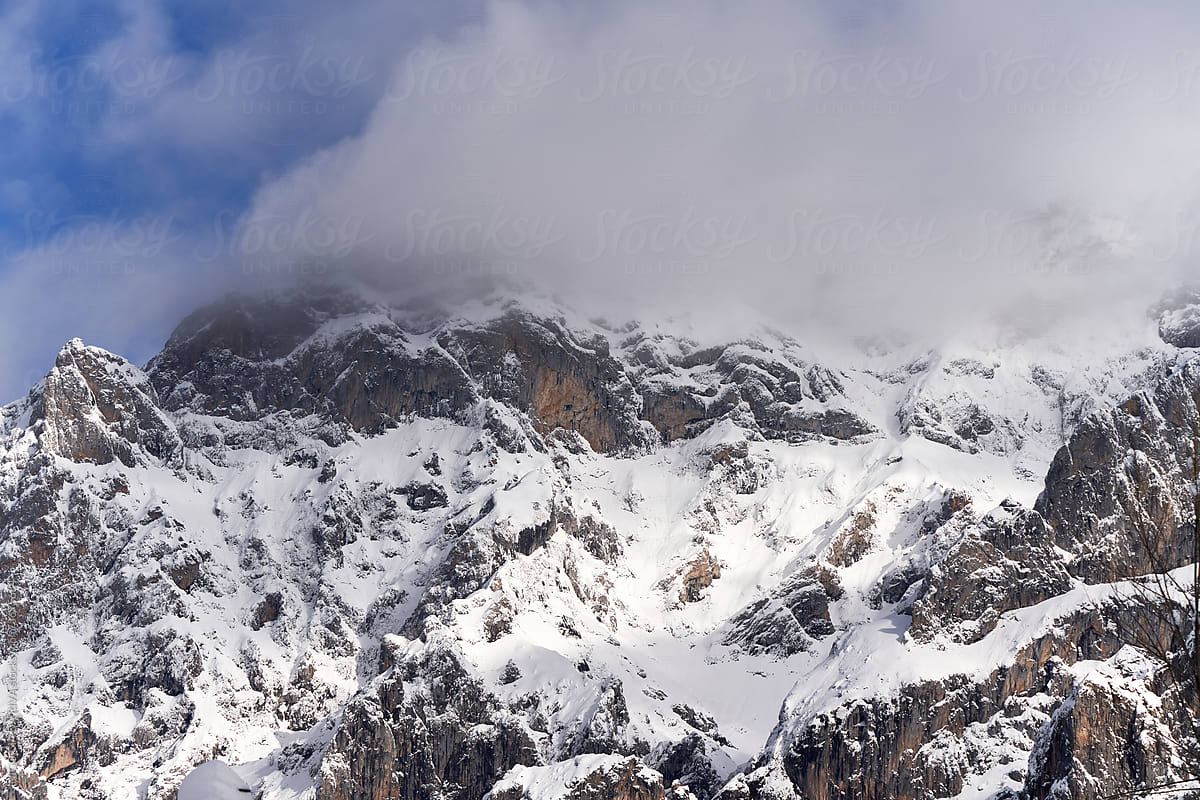 Severe landscape with snowy rocky mountain peak