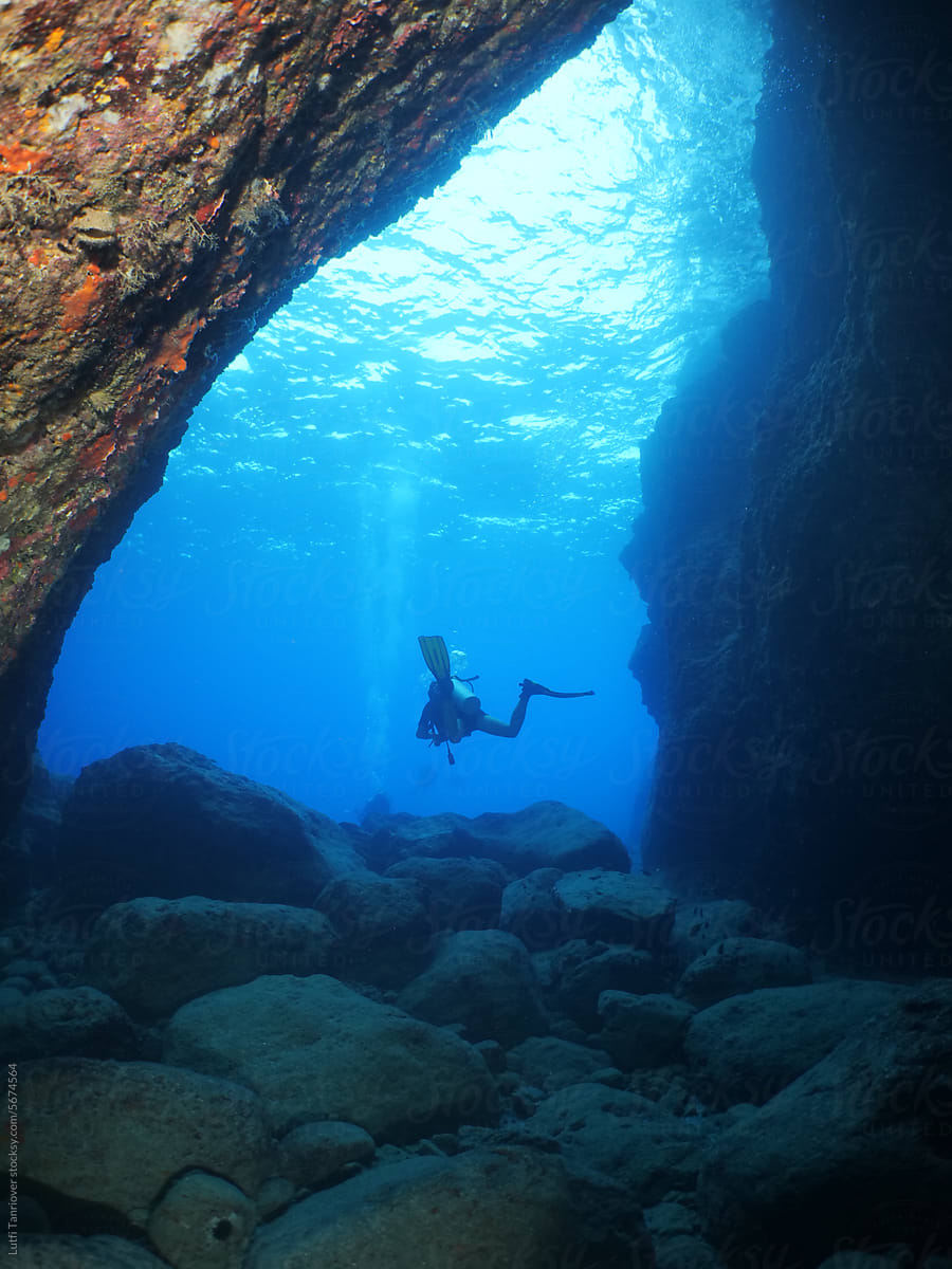 cave diving underwater scuba divers exploring caves