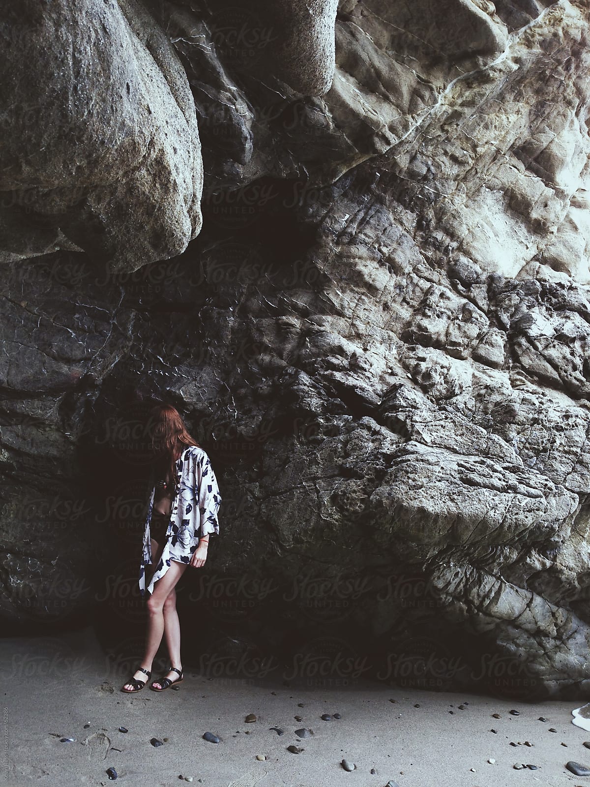 Woman Standing Under Large Cave Rock By Stocksy Contributor Kevin Russ Stocksy