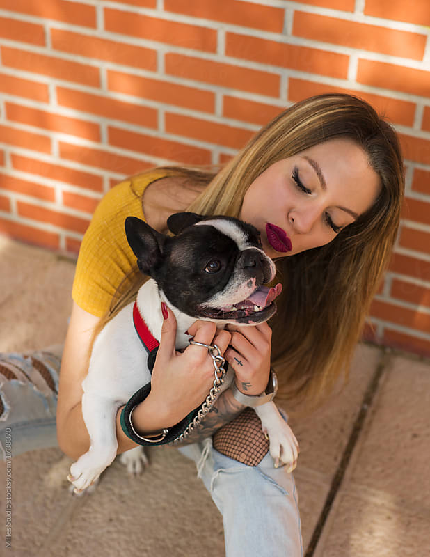 Content woman with adorable French bulldog