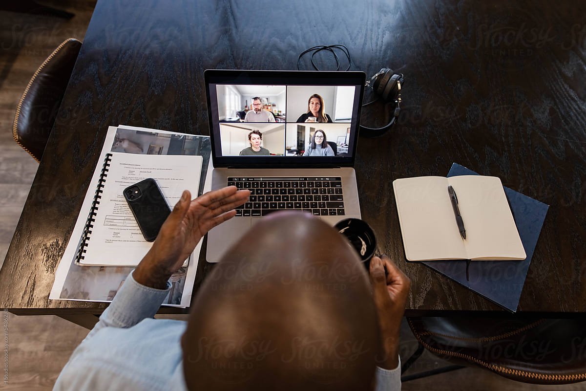 Businessman video conferencing meeting with colleagues on laptop
