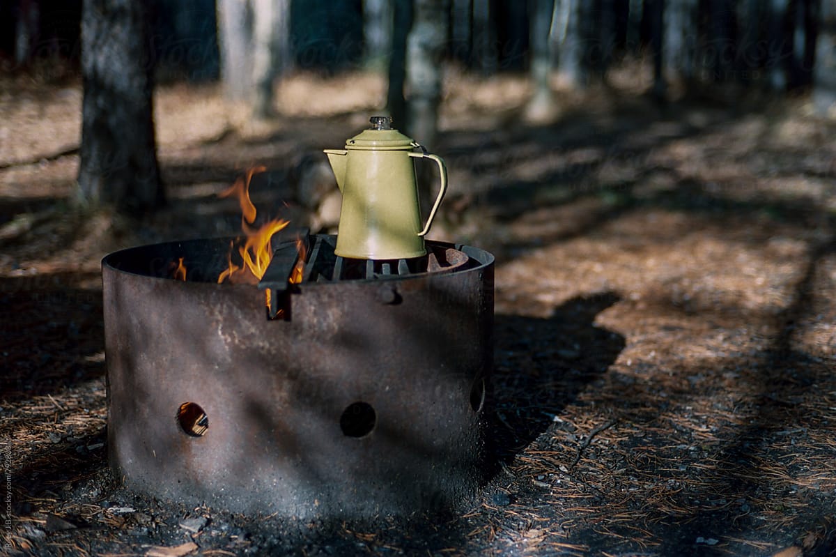 An enamel kettle on a campfire