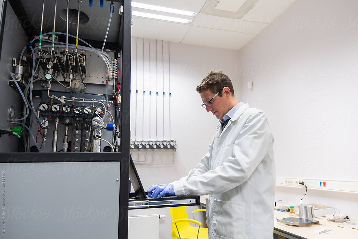 Researcher Using Computer In Electrochemistry Lab