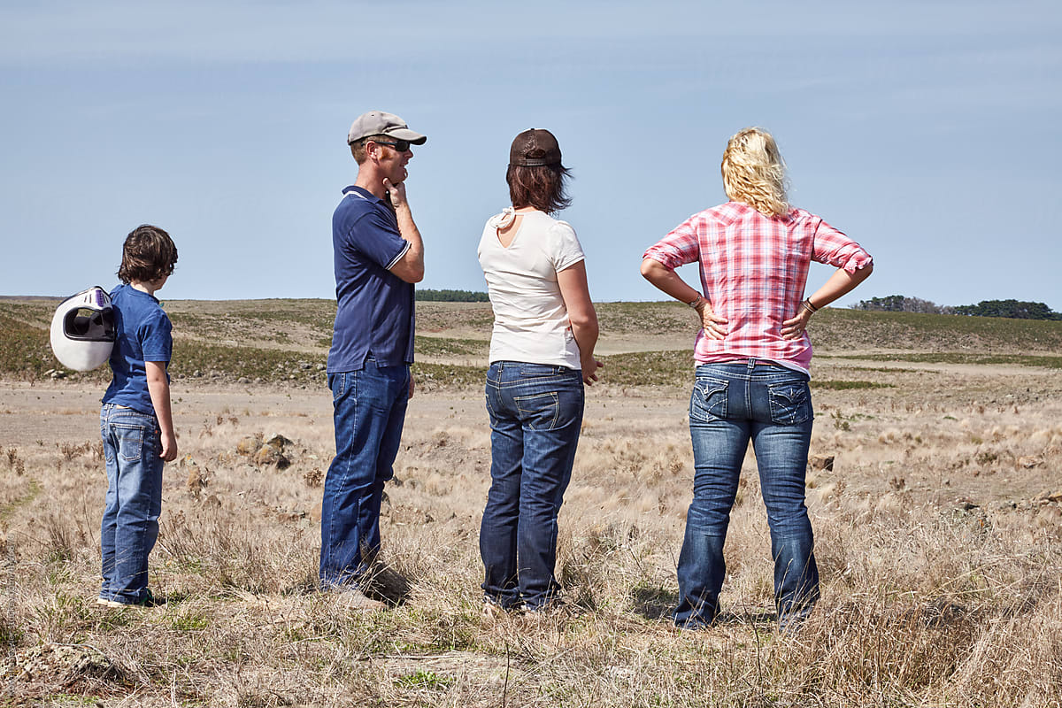 Farming family look out over dry farm land