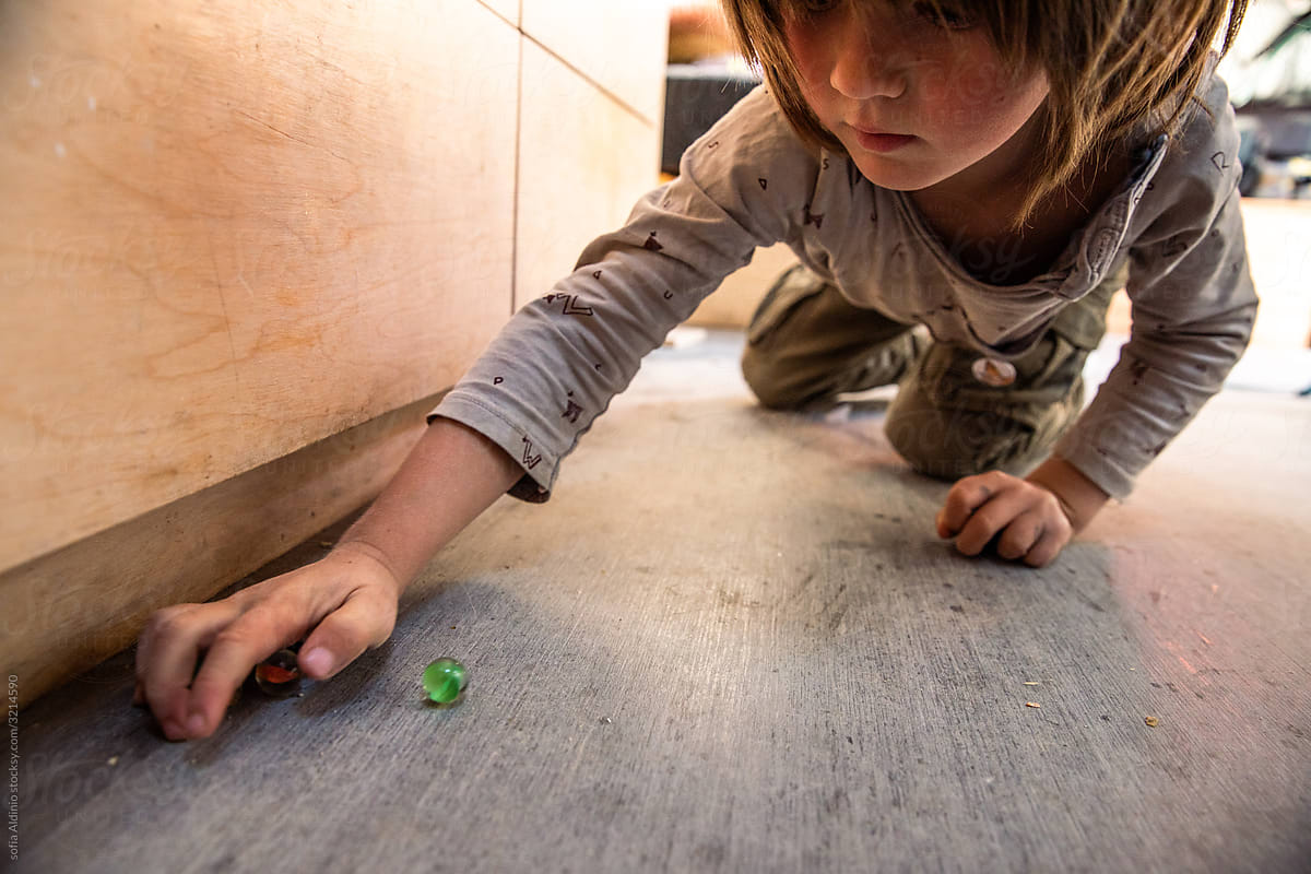 Kid playing Marbles at home