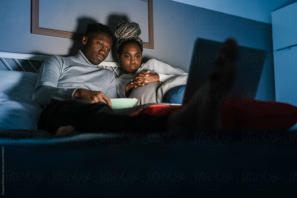Couple watching interesting film in evening