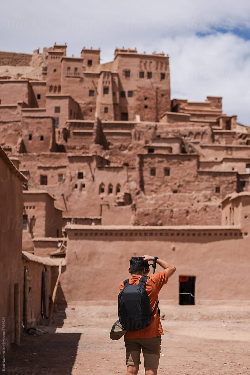man taking pictures on vacation in morocco.