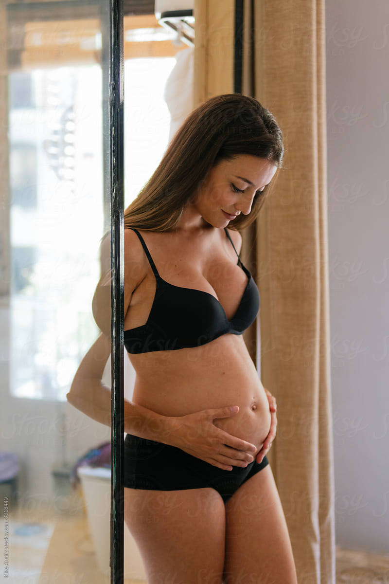 Pregnant woman in underwear Stock Photo by ©robertprzybysz 61912267