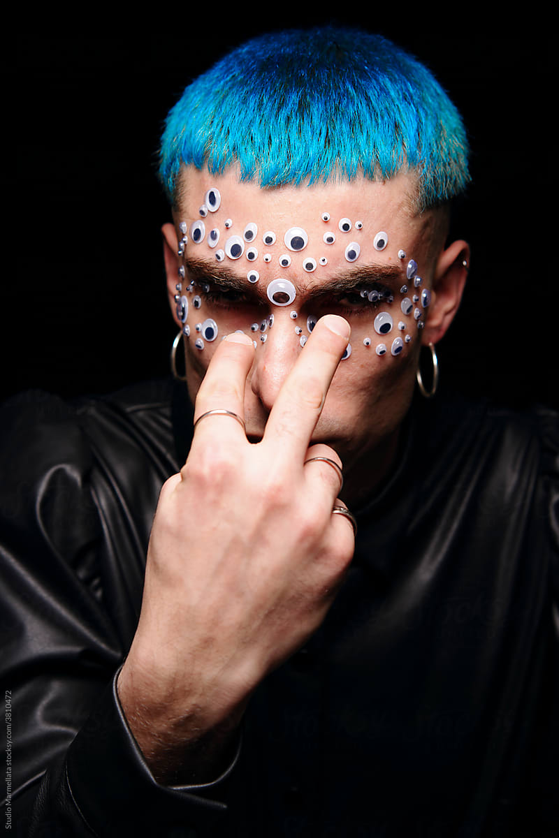Male model with eye stickers on face in studio