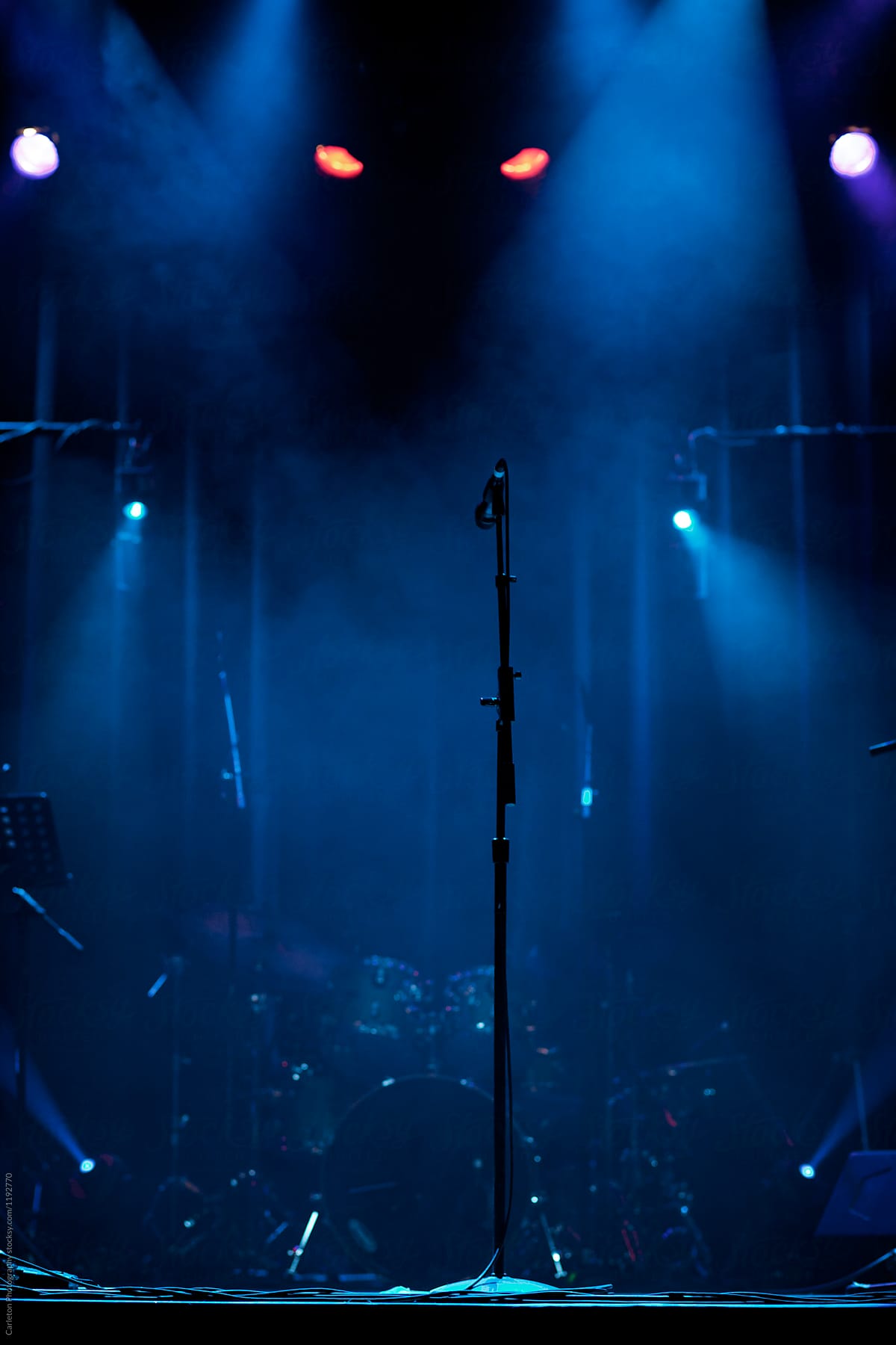Microphone on stage with creepy lights behind