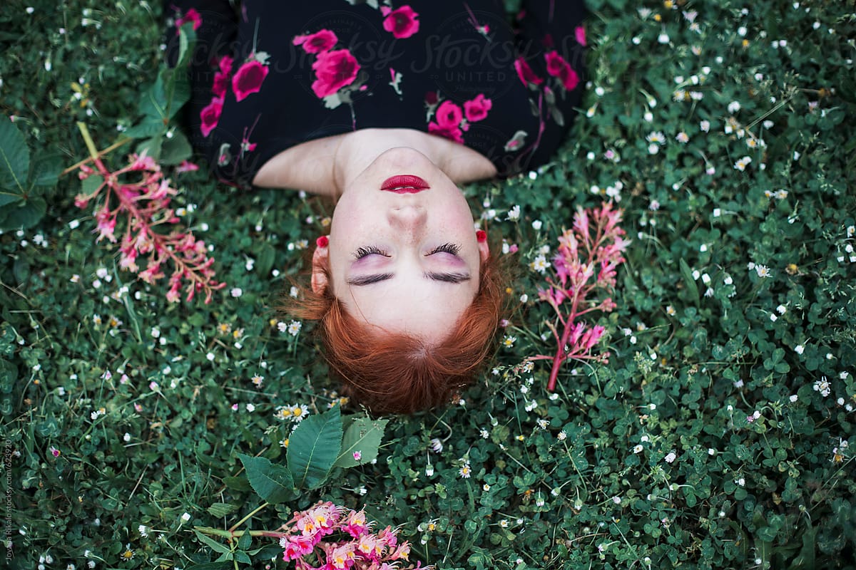 Ginger Haired Woman Laying On The Grass By Stocksy Contributor Jovana Rikalo Stocksy
