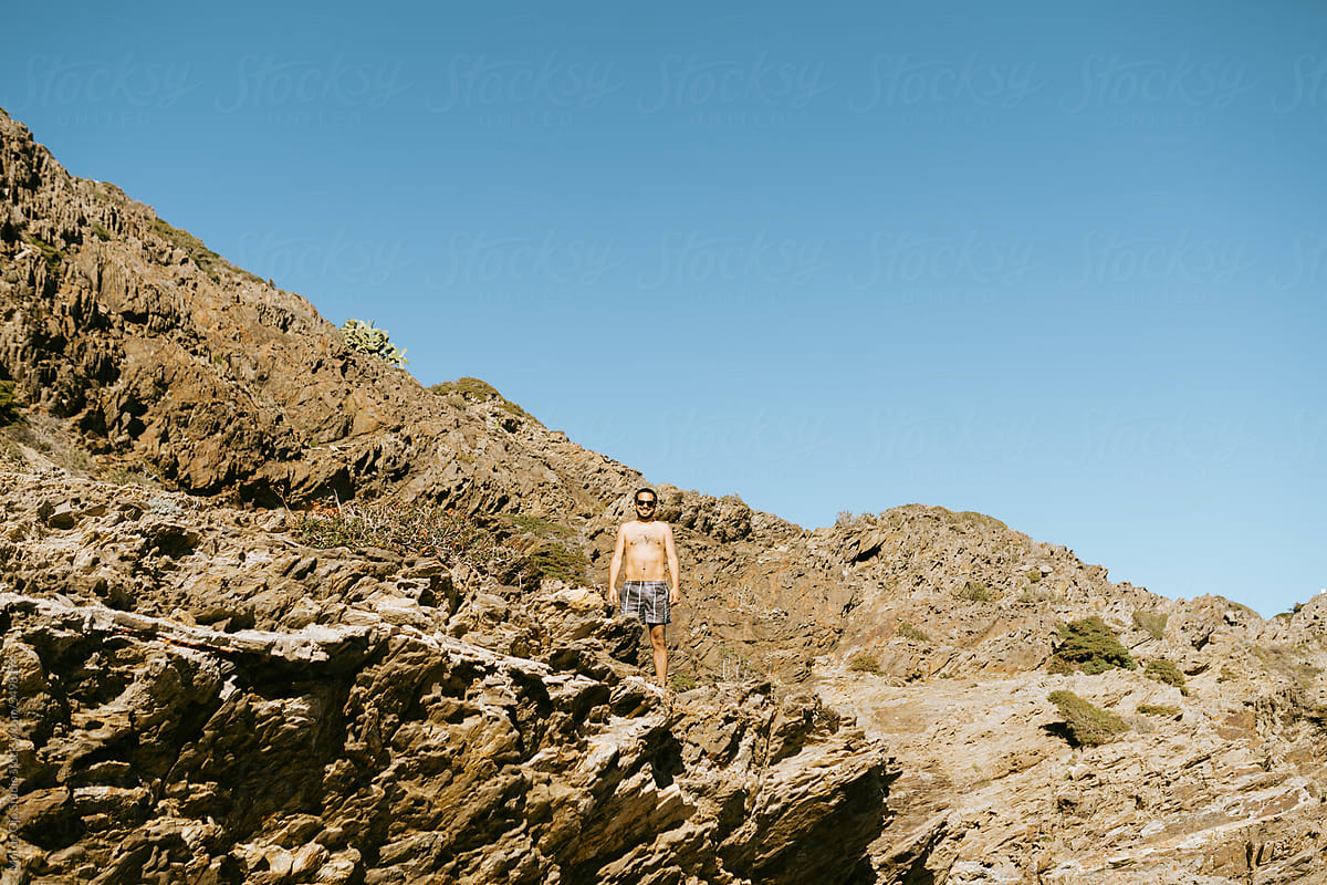 Shirtless Man in Rocky Landscape