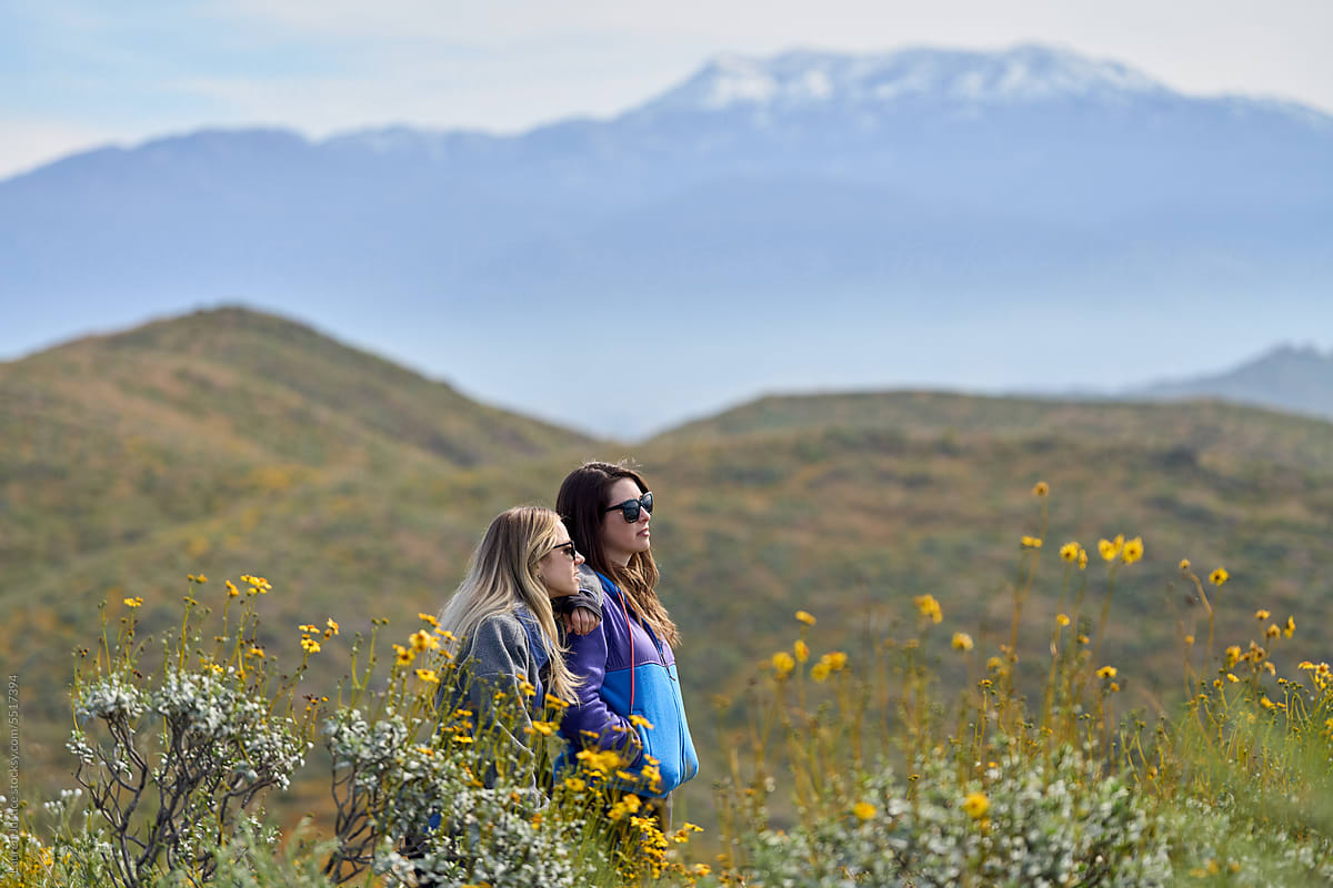 Two girls overlook the mountainous scenery