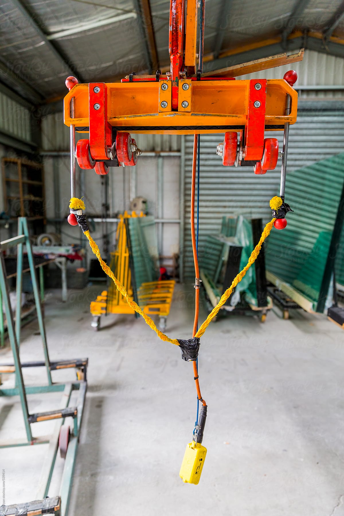 Specialised crane for loading glass panels to a cutting bed