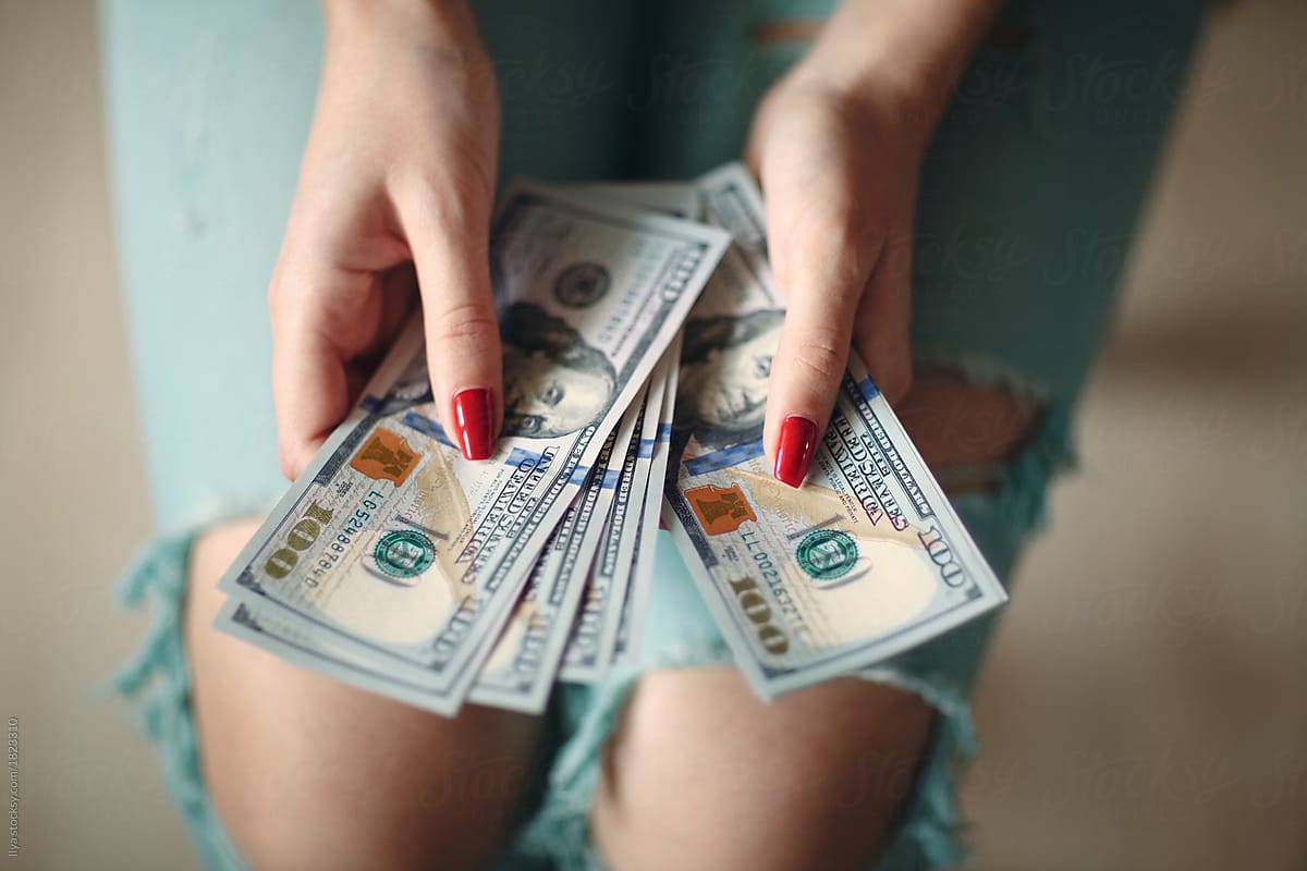 Woman holding money dollars