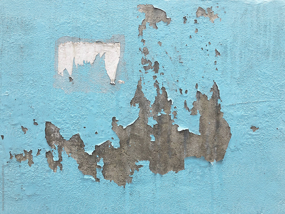 Background of a weathered wall with paint peeling off of it.