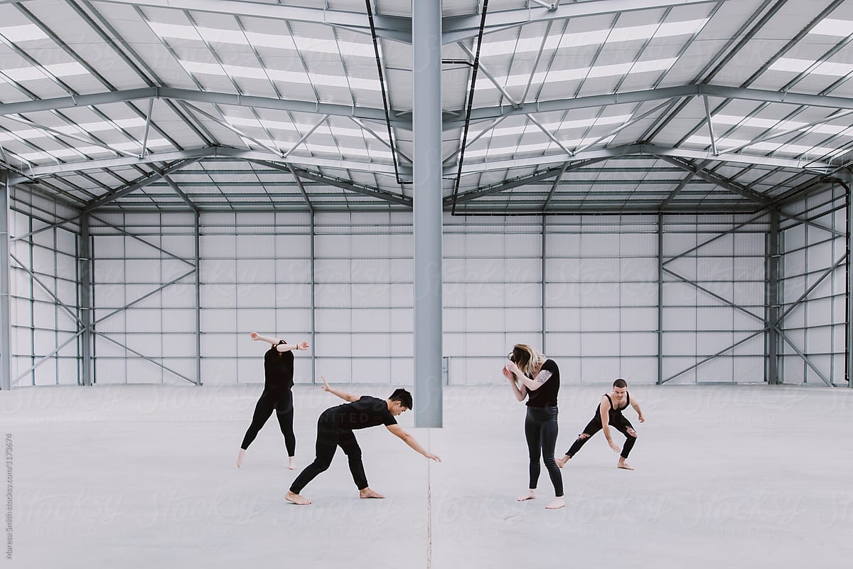 Four dancers in an empty warehouse expressing different emotions through their movements