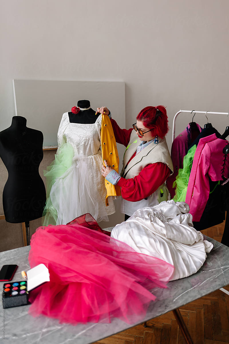Redhead clothing designer dressmaker creating wedding dress