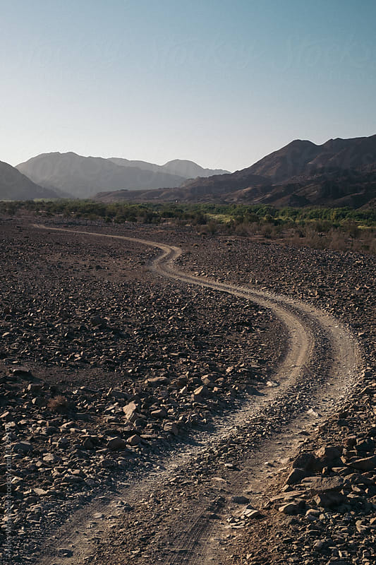 Winding dirt track in a rocky desert landscape
