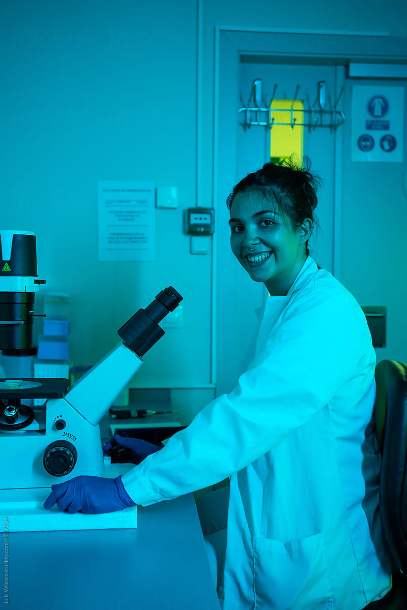 Portrait Of A Scientist Woman Using A Microscope in The Laboratory.