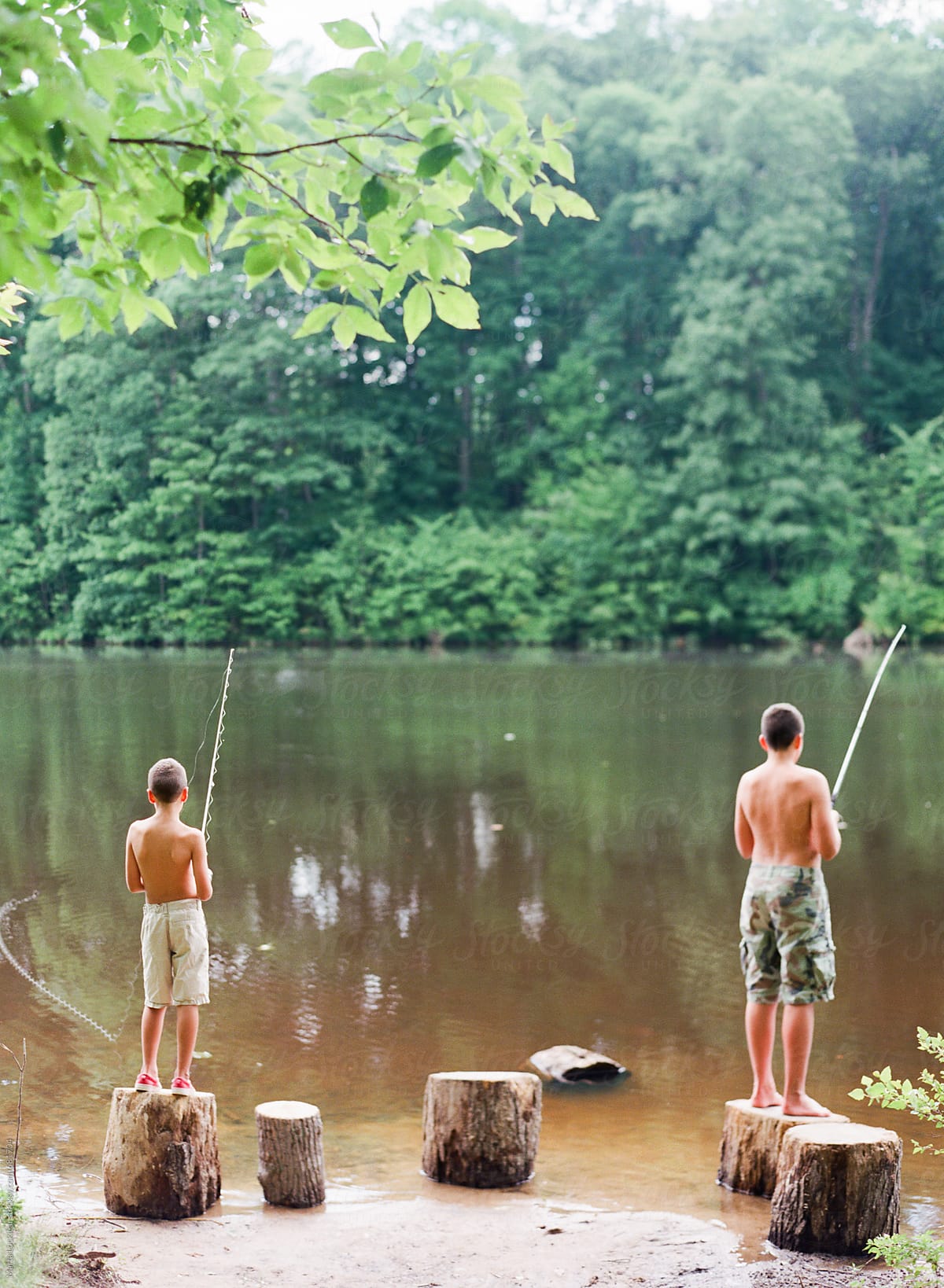 Two Boys Fishing by Stocksy Contributor Marta Locklear - Stocksy