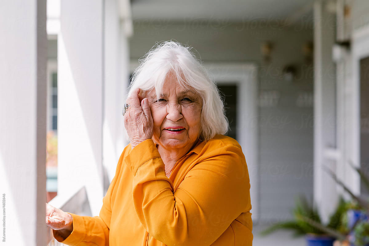 White hair senior woman squishing eyes residence portrait