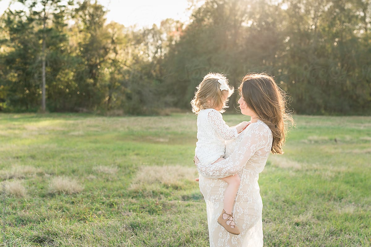 A Mother Holds Her Daughter By Stocksy Contributor Alison Winterroth