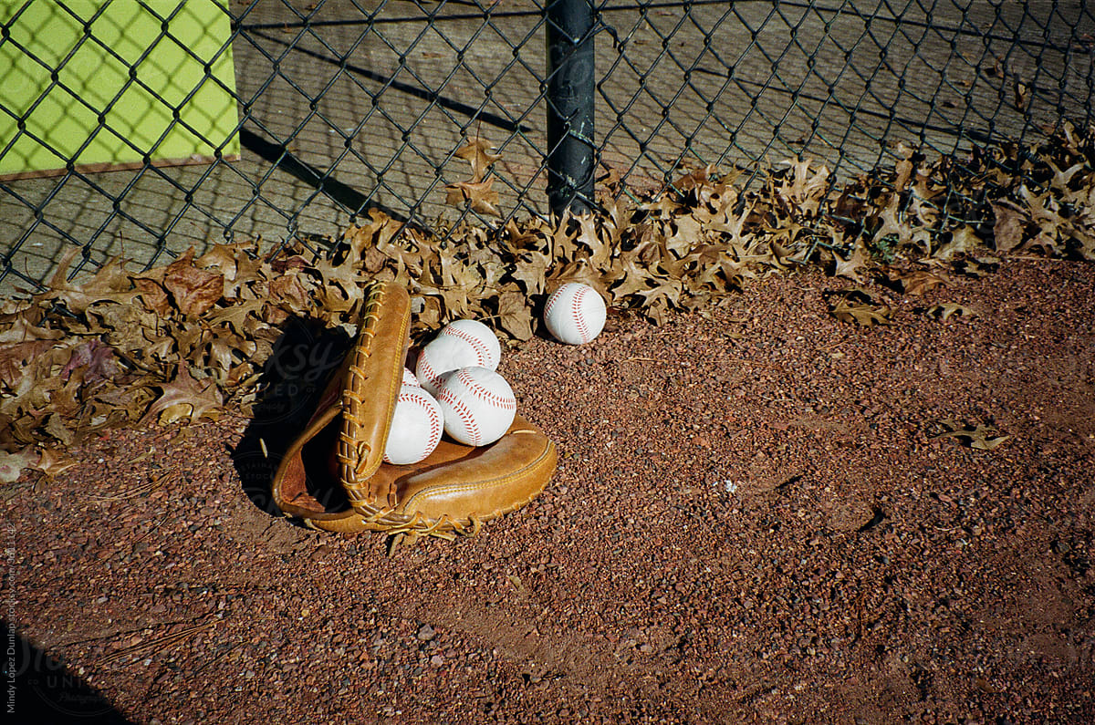 Baseball glove and baseballs on a field