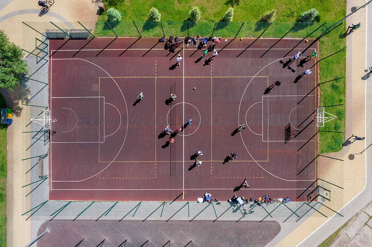 Aerial view on outdoor basketball court with people playing games