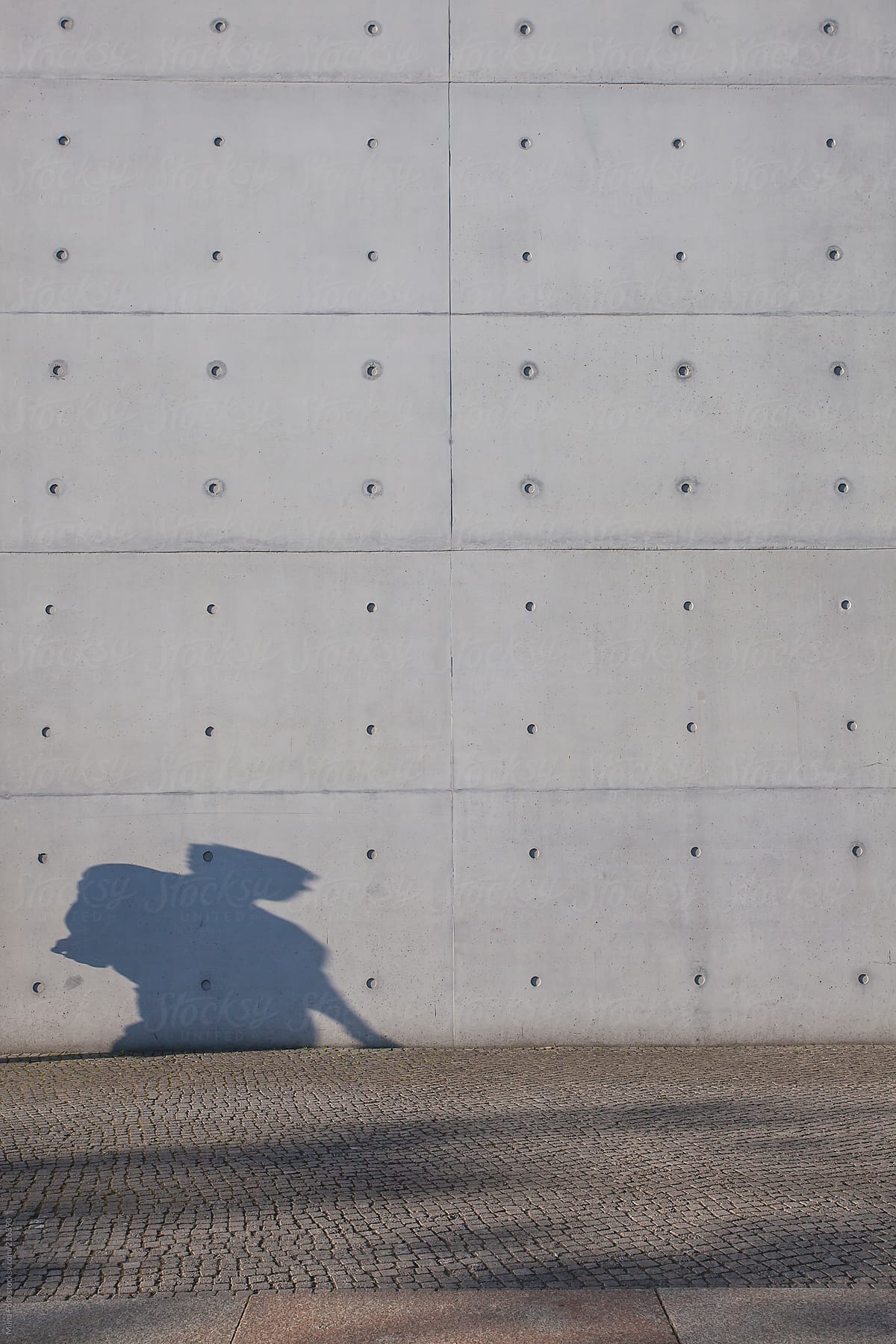 Shadow of Man walking, huge wall