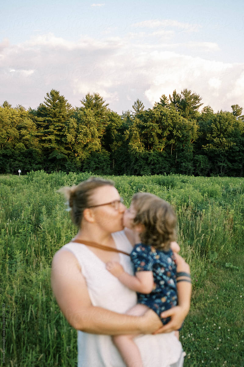 mother and daughter outside, with a focus on rural landscape
