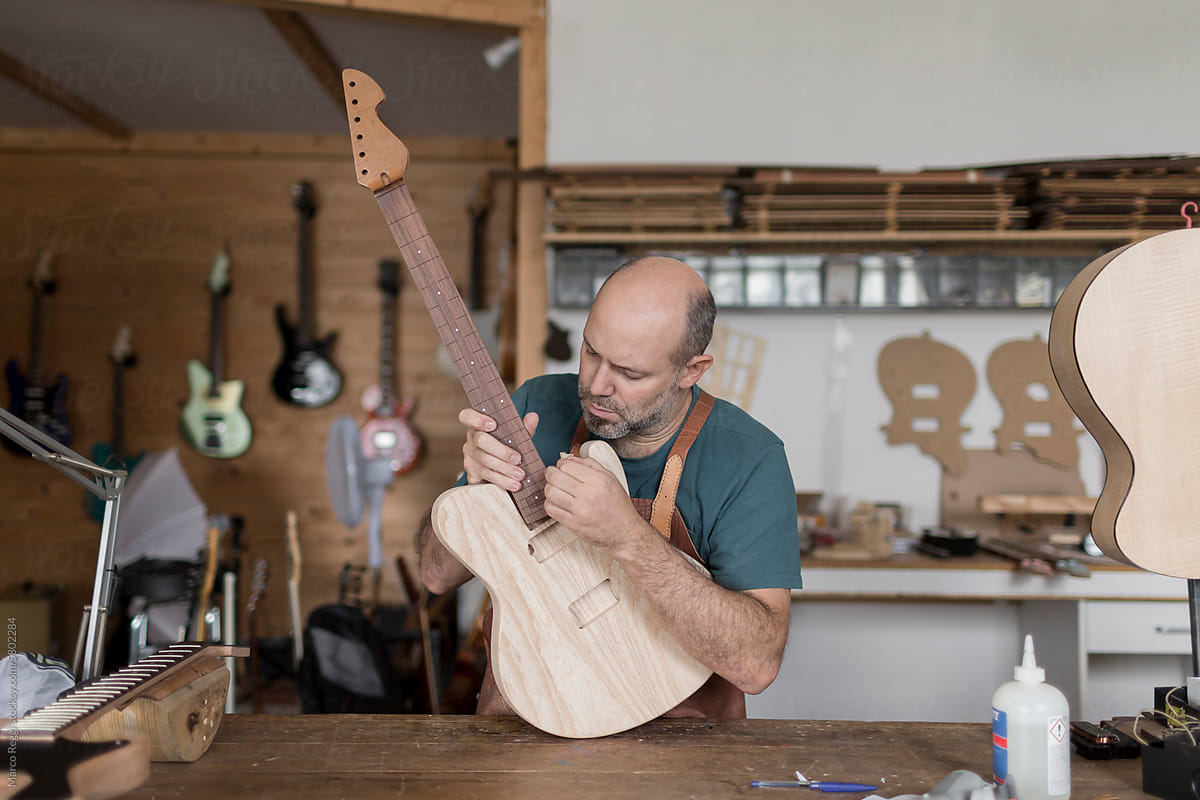 Luthier Repairing a guitar