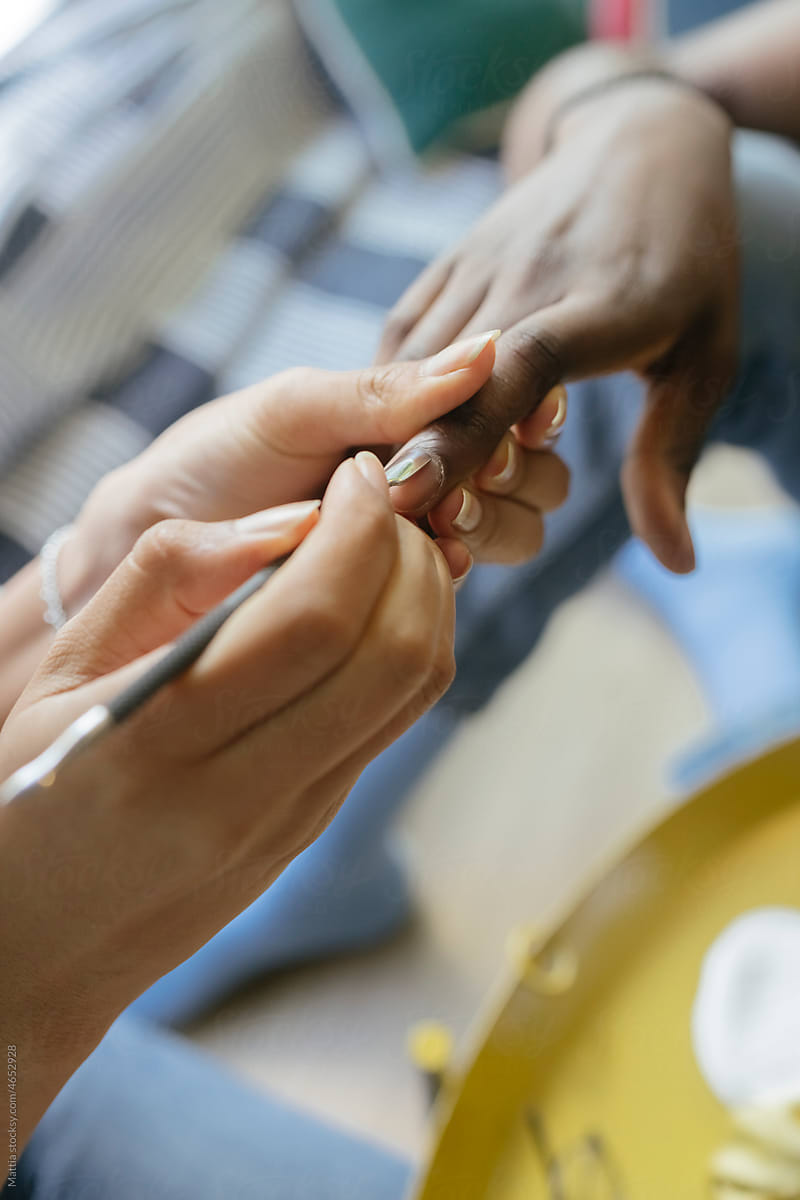 Female Afro Woman doing Manicure