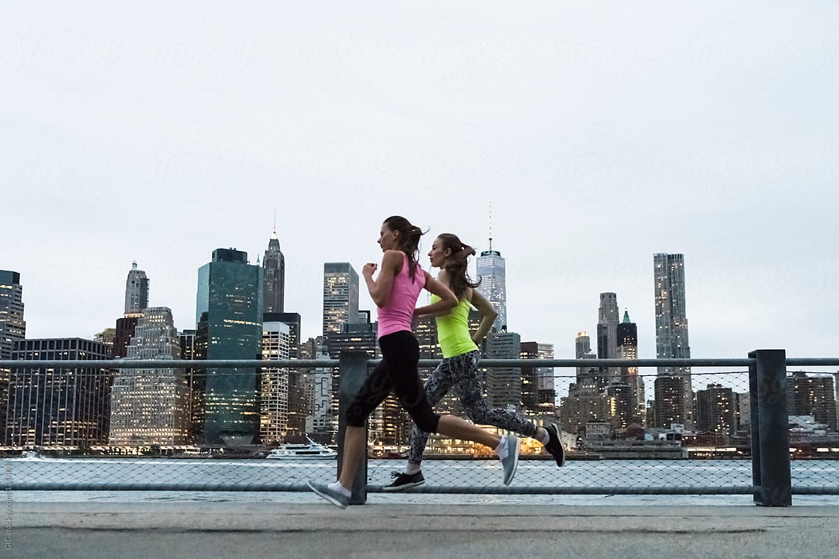 Young women jogging in New York City at twilight