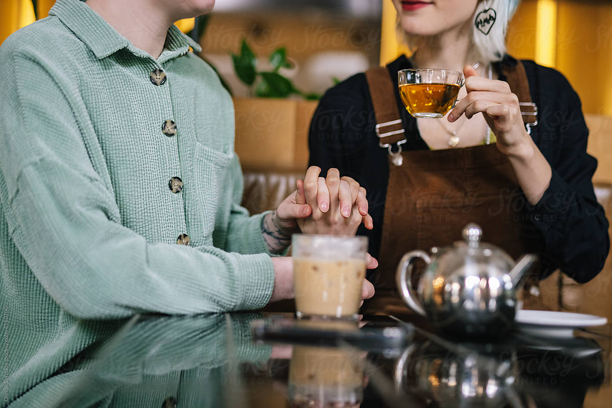 Couple in love enjoying beverages in public place