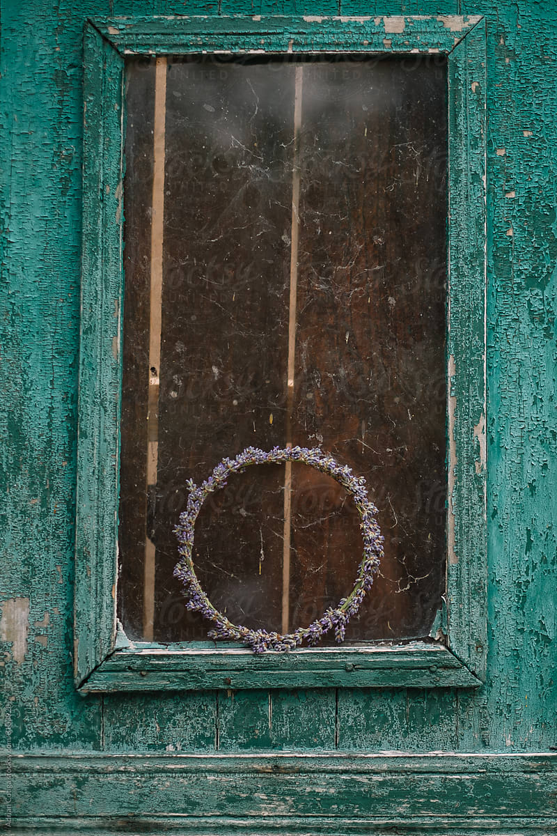 Old painted blue door decorated with an lavender wreath