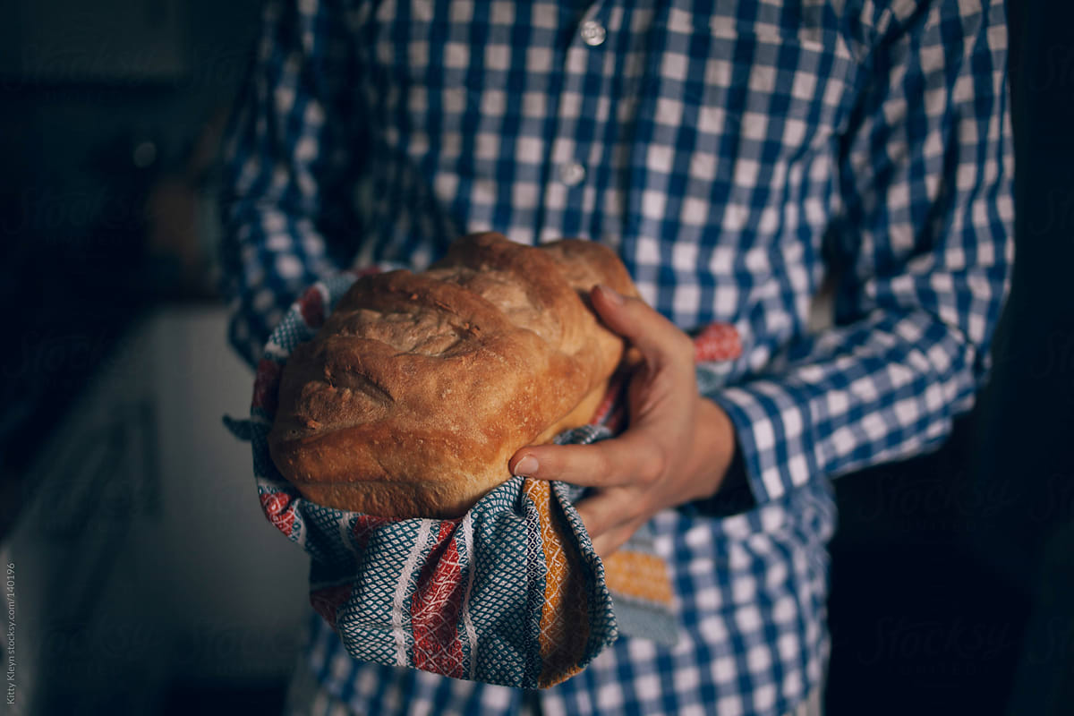 Man holding freshly baked bread