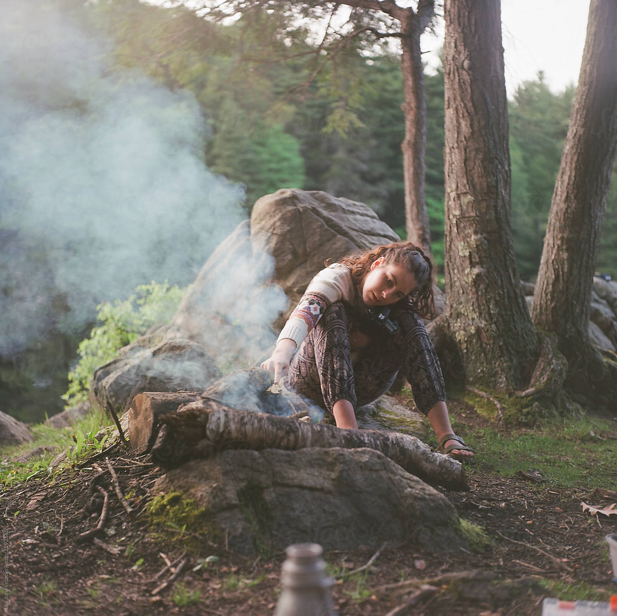 teen girl by campfire