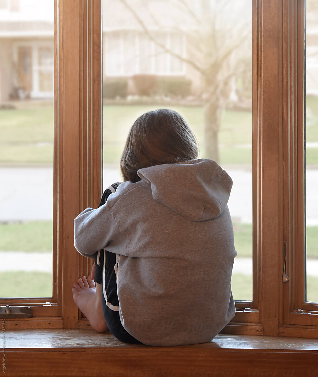 Lonely Child Looking Outside Her Window