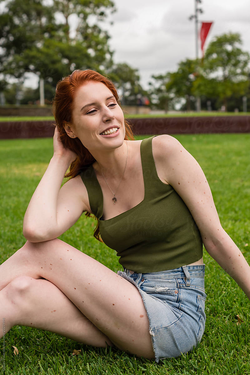 uni student sitting on grass on campus