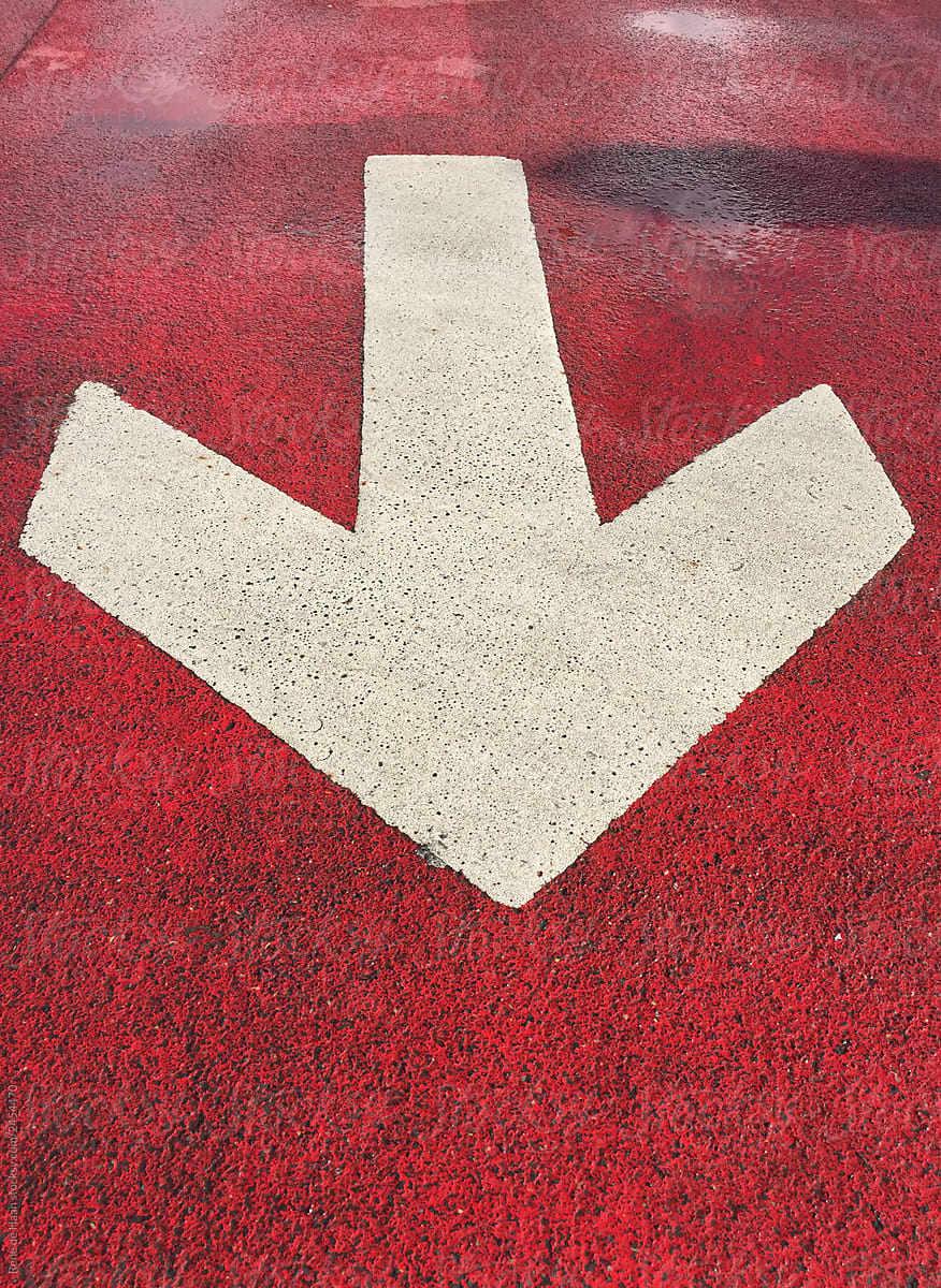 big white arrow on red floor