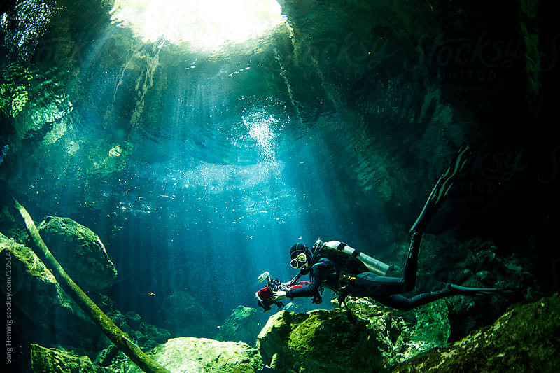 A scuba diver swimming in Mexico's Tajma ha Cenote