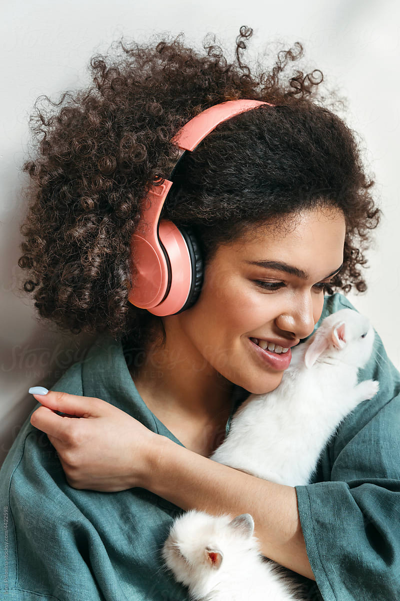Young mixed-race woman listens to music.