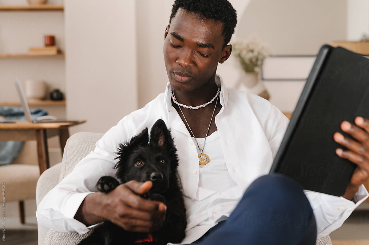 A man with dog using tablet