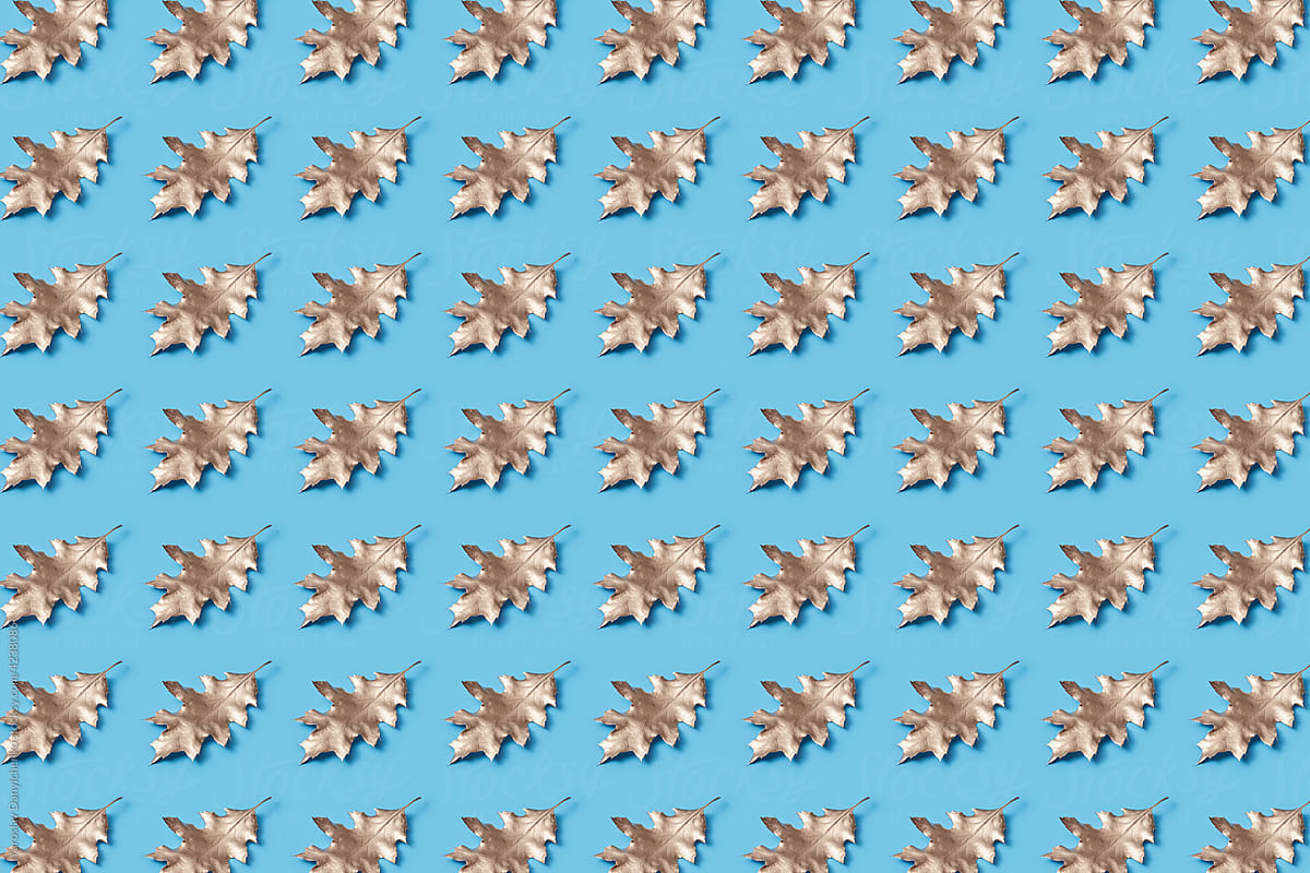 Pattern of painted leaves on blue background