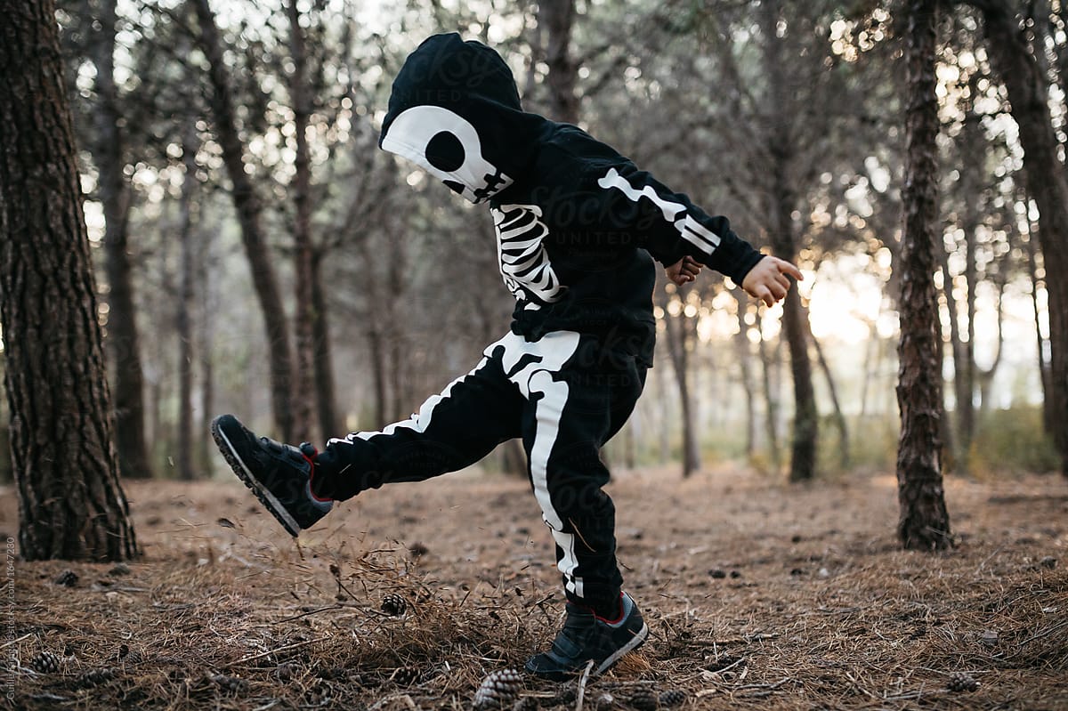 Child in skeleton costume having fun