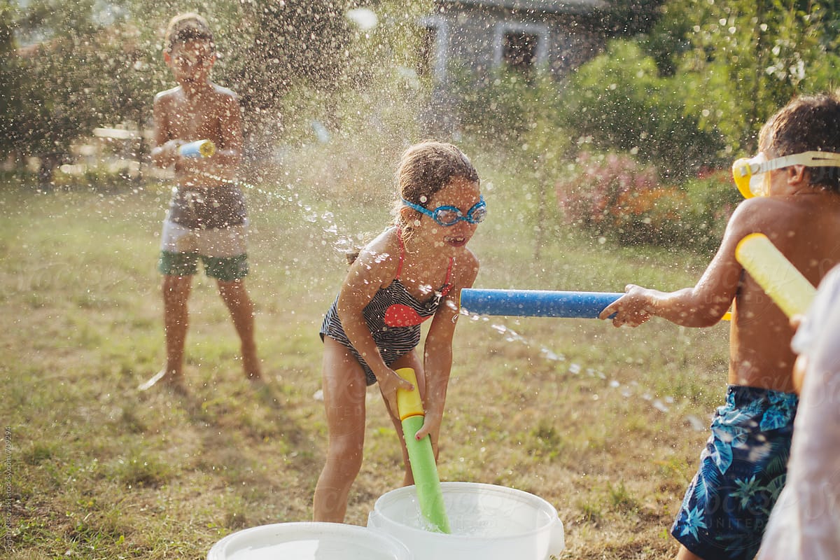 Children splashing with water guns.