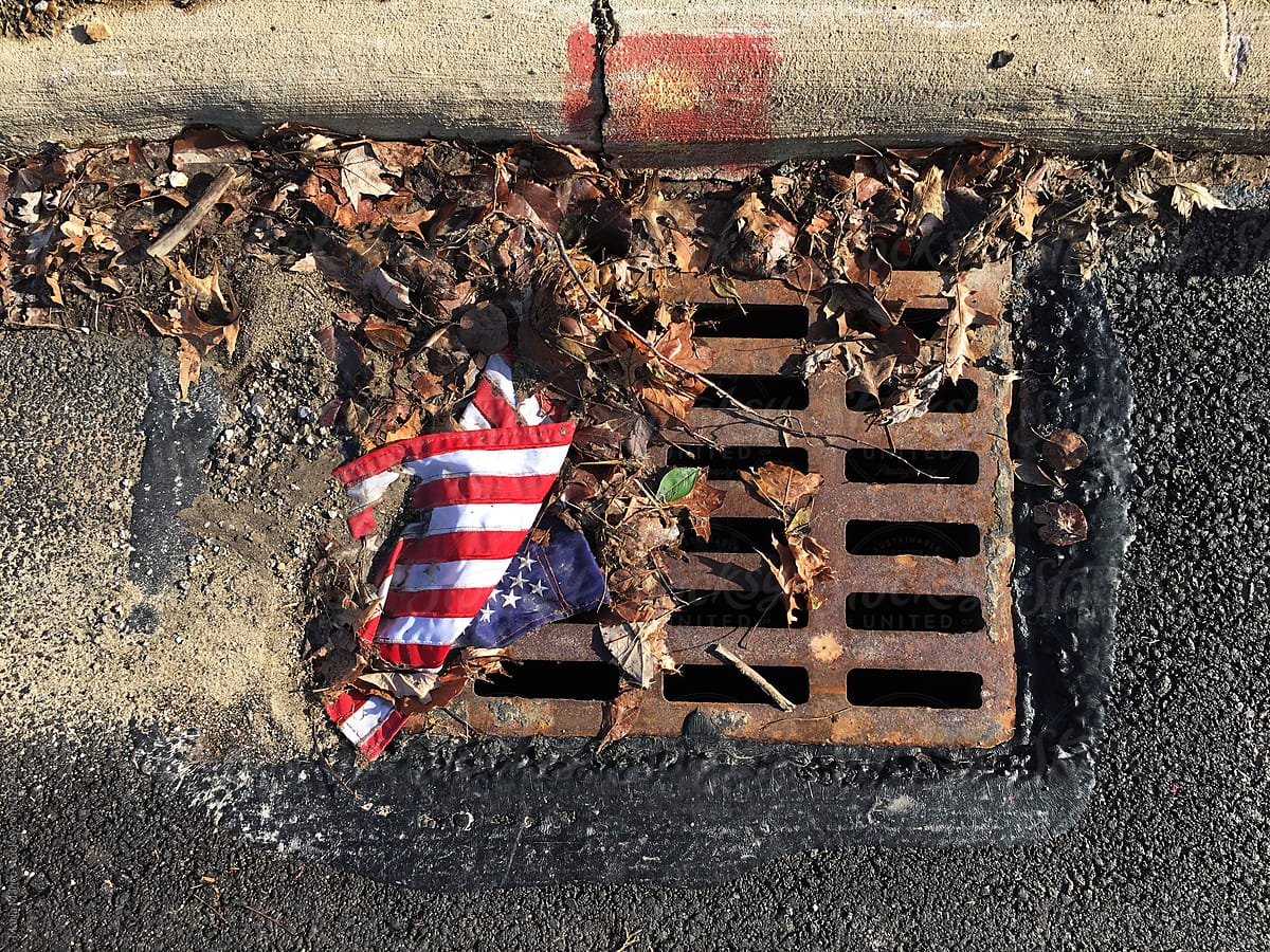 American flag in gutter