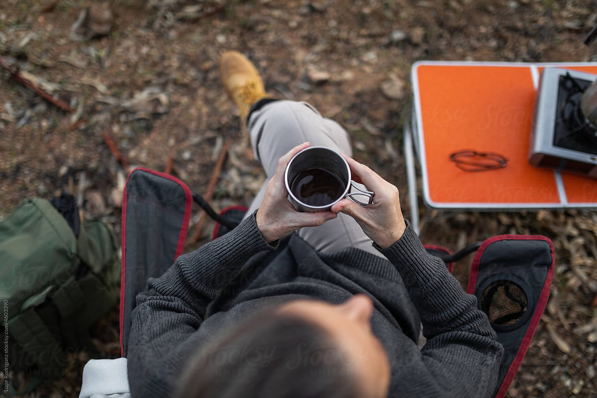 woman sitting in nature drinking coffee